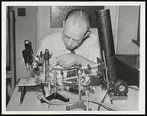 Views Death Inside Body. Dr. Melvin H. Knisely, of the University of Chicago, is shown with his device which shows the arrival of death in the human body. The view of the behavior of the inside of the body covers the period of the two to five final moments, the so-called agonal moments before and after the heart stops.