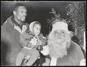 Minor Troubles came for Celtics’ star Bill Russell when his daughter, two-year-old Karen, had to be coaxed into making friends with bewhiskered Santa.