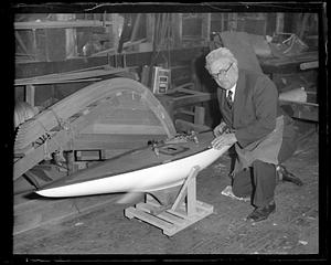 Boat builder Fred Pigeon works on miniature yacht