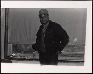 Man smiling in front of window