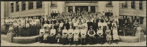 Portrait of people posed in front of a building