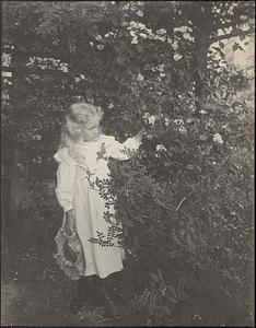 Girl standing among flowers