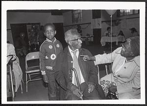 Young boy, older man and woman talking