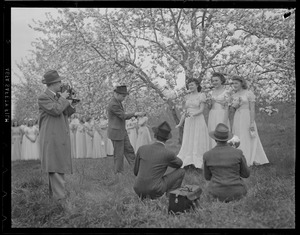 Photographers take pictures of three of the singers at the Apple Blossom Festival