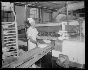 Charlie Sizilis placing pies in the oven, Table Talk factory in Worcester