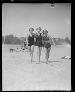 Three women sporting the latest styles at the beach