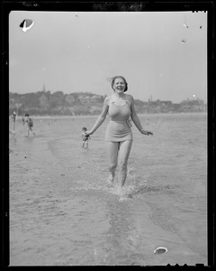 Wading woman finds the water at the beach a little cold
