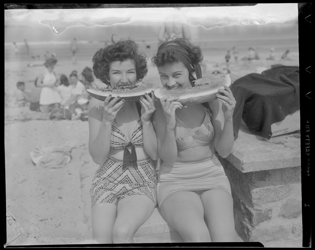 Girls eating watermelon at the beach