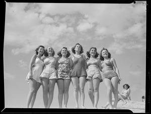 Lovely ladies model suits at the beach