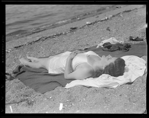 Woman sunbathing on beach