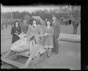Women pose with bomb