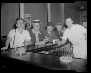 Bartender poses with line of patrons