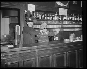 Cop pretends to arrest bartender at bar with shark jaw