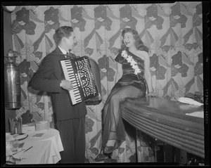 People: Accordion serenade for girl at the bar