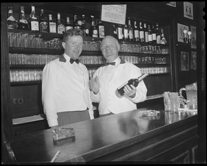 Bartenders at bar with shark jaw