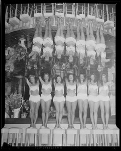 Double dose of chorus girls reflected in ceiling glass