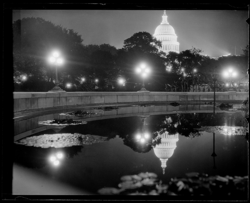 U.S. Capitol at night, reflected in pool