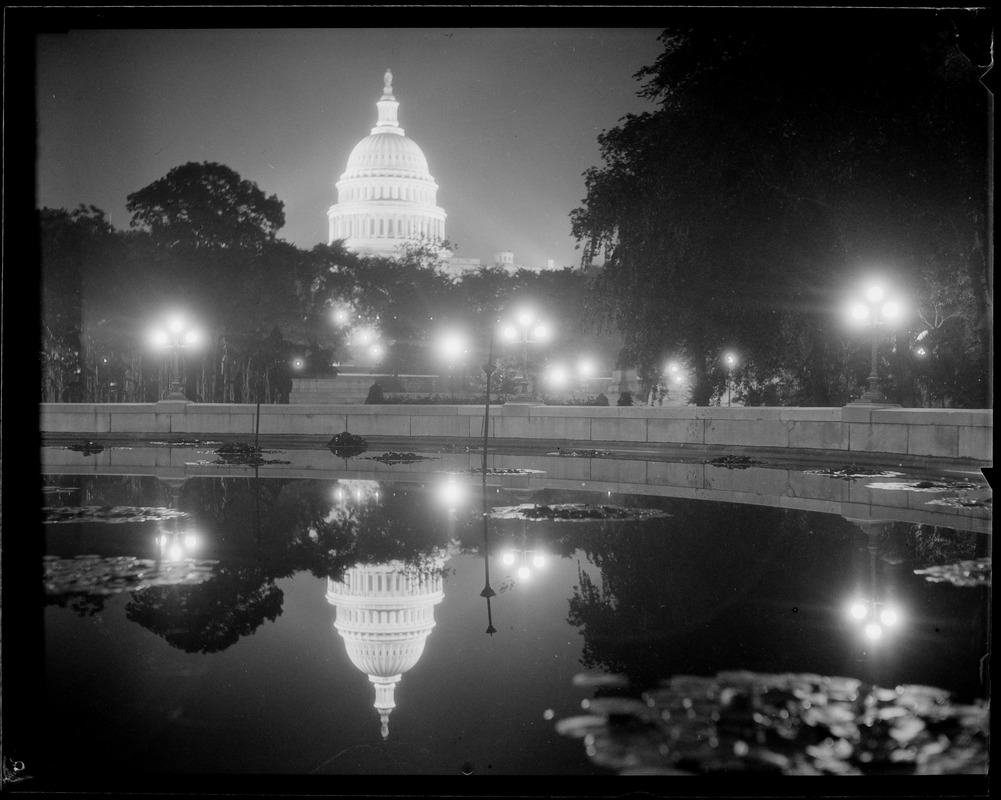 U.S. Capitol at night, reflected in pool