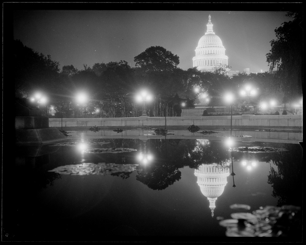U.S. Capitol at night, reflected in pool