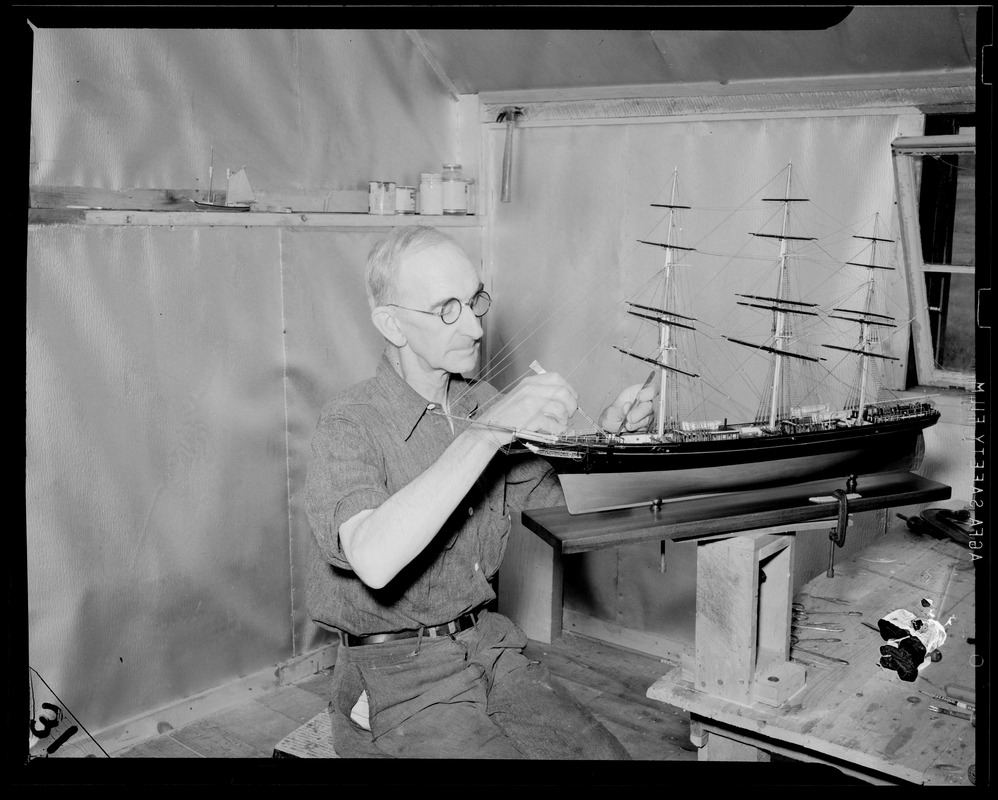 Man building model of boat