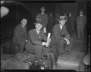 Group of men waiting with their luggage