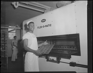 Black worker making muffins