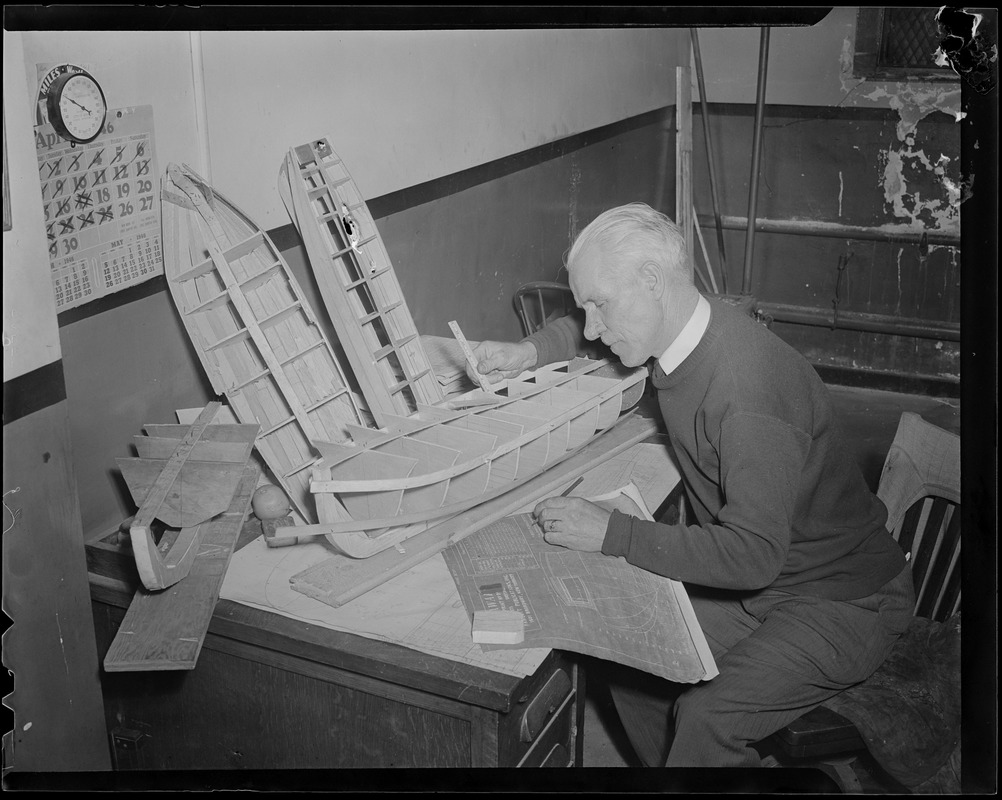 Man making model boat, Boston School Dept.