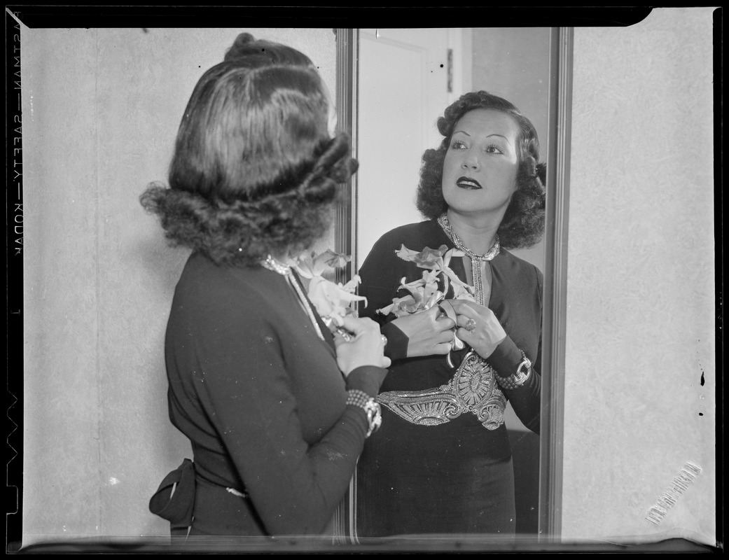 Woman admires corsage in mirror