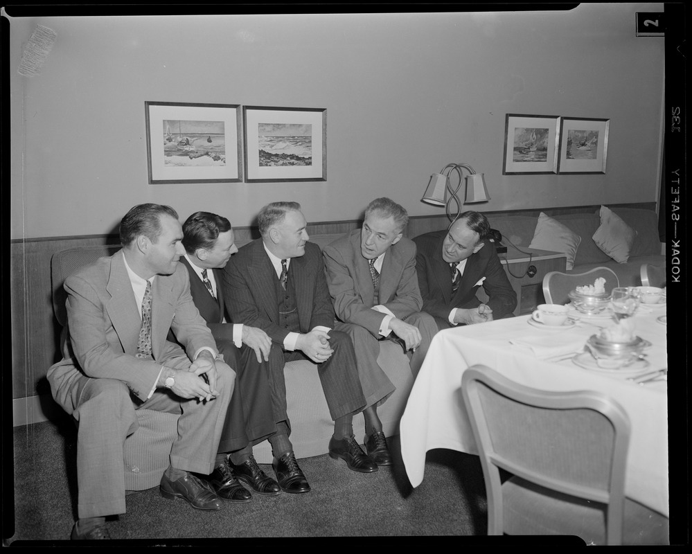 Unidentified group of men sitting on couch