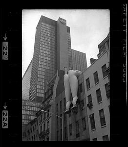 Inflatable legs hang from side of building, New York City