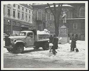 Snow being shoveled onto a truck next Benjamin Franklin statue, Boston