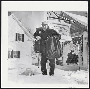 Postmaster Waits in Vain -- Fred Bearse, South Chatham postmaster, mail pouch over his arm, waits in vain for truck to make daily pickup as Cape Cod is hit by worst storm in 50 years.