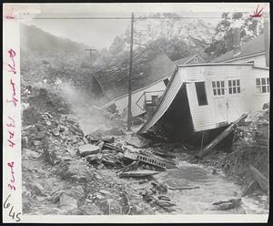 Storm Damages Pennsylvania Town-Buildings dip crazily into gully created by rushing flood waters in West Nanticoke, near Wilkes-Barre, as thunderstorms pour four and one-half inches of rain into the Wyoming valley.