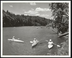 Kayaks on the Androscoggin River, Errol, N.H. State of N.H. Photo by Dick Smith. The Quiet Sport-- One of the very prettiest and quietest sports is canoe and kayak racing. Dozens of water sports enthusiast pit their skills against one another each spring and fall on the tumbling, thrashing Androscoggin River near Errol, N.H. Note the peaks of the softwood trees in this picture. They explain why the area is often described as New Hampshire's Christmas Tree Country. There are literally hundreds of unbroken square miles of this tree specie on New Hampshire's northern border.