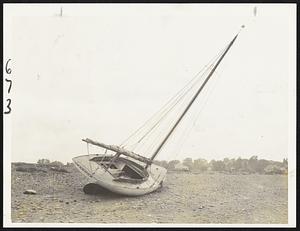 This yacht was swept high and dry on the Savin Hill beach today during the height of the gale.
