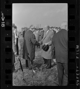 Sears president, Crowdus Baker, shaking hands with an unidentified man, most likely Harold G. Kern, publisher of the Record American-Sunday Advertiser, at the groundbreaking for the new Sears Distributing Center