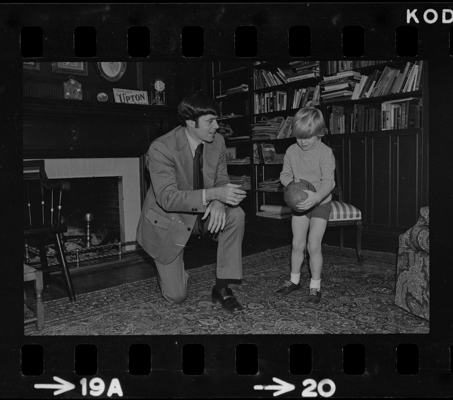 Patriots General manager, Upton Bell, at home playing with his son Christopher