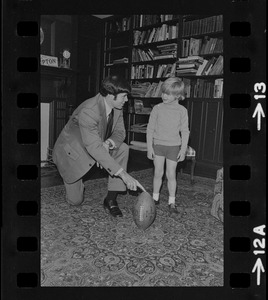 Patriots General manager, Upton Bell, at home playing with his son Christopher