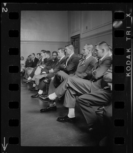 A group of men, most likely new police officers, sitting in a Boston Municipal Courtroom while Judge Adlow presides over a session