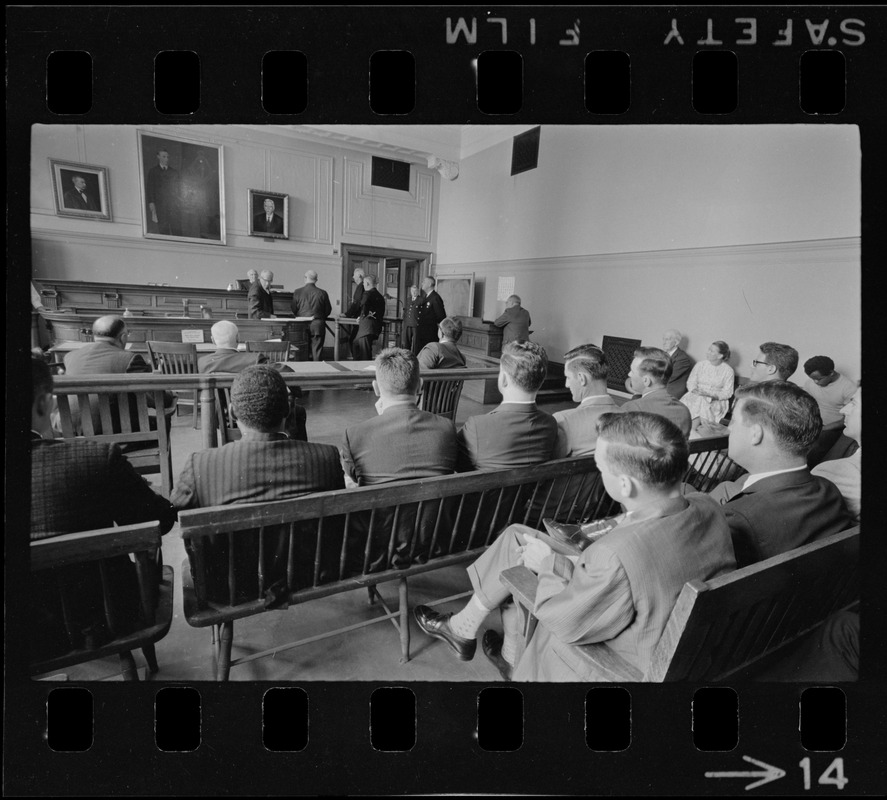 Judge Adlow presiding over a session in Boston Municipal Courtroom where new police officers are observing