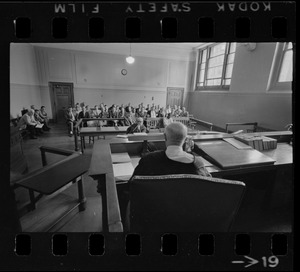 Judge Adlow seen from behind presiding over a session in Boston Municipal Courtroom
