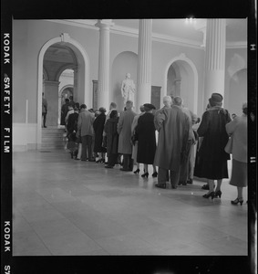 Mourners lining up through Doric Hall in the State House to pay respects to James M. Curley