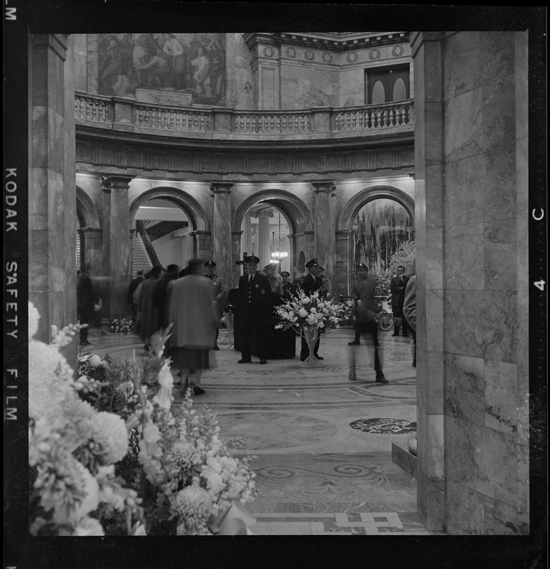 This view of the State House Hall of Flags rotunda captures part of the beautiful floral display which scented the air where the mortal remains of the late ex-Gov. James M. Curley are being viewed by thousands of mourners