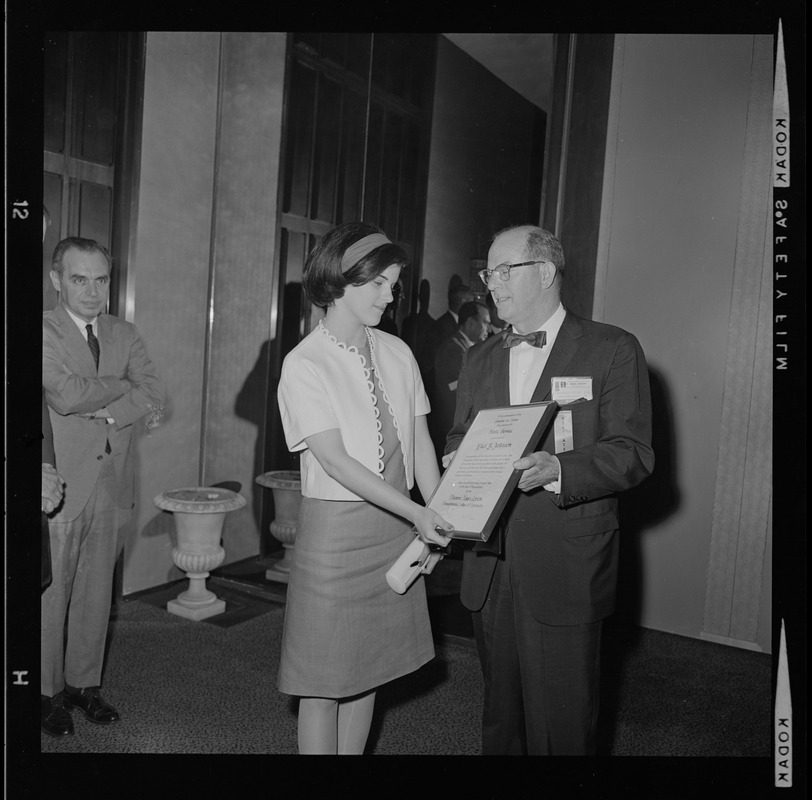 Luci Johnson receiving a certificate for Public Service from the Pennsylvania College of Optometry by Dr. Lawrence Fitch at the American Optometric Association convention