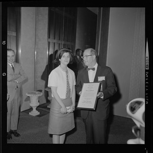 Luci Johnson receiving a certificate for Public Service from the Pennsylvania College of Optometry by Dr. Lawrence Fitch at the American Optometric Association convention