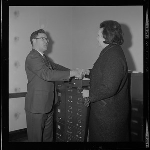 Louise Day Hicks shakes hands with an unidentified man at the Dorchester Court