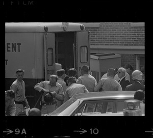 Police standing by their trucks, most likely near Jeremiah E. Burke High School during student demonstrations