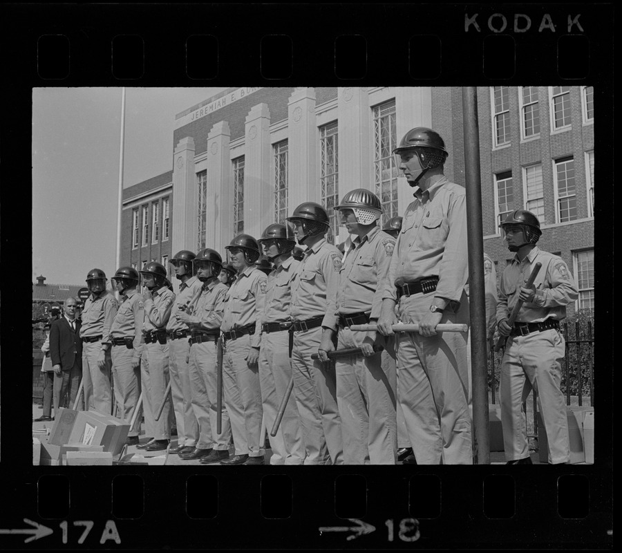 Riot police lined up in front of Jeremiah E. Burke High School after unrest broke out during student demonstrations