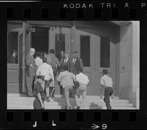 Headmaster Joseph Malone of English High School, far left, waving students through door, most likely during student demonstrations