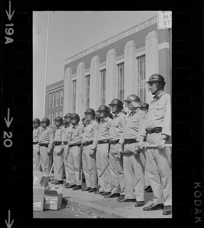 Line of riot cops outside of Jeremiah E. Burke High School during ...